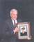 Joe displaying a picture from his Navy days