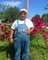 Gpa in front of Nanny's rosebush
