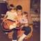 Scott at 11 years old, showing Ian and Tasha how to play the guitar.